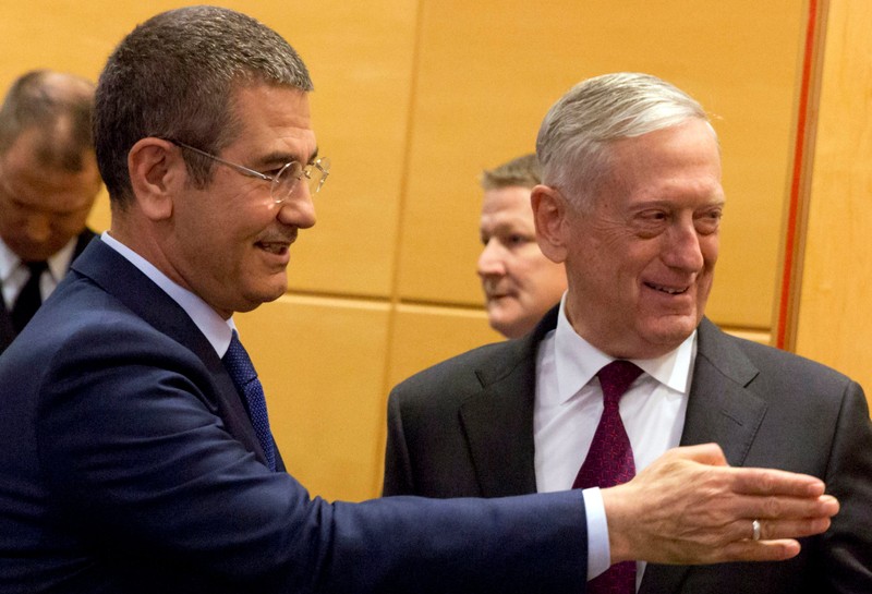 U.S. Secretary of Defence Mattis poses with Turkish Defence Minister Canikli during a NATO defence ministers meeting in Brussels