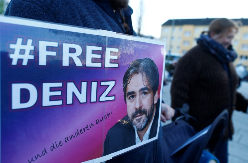 A protester carries a placard during a demonstration to support German-Turkish journalist Deniz Yucel in Floersheim near Frankfurt
