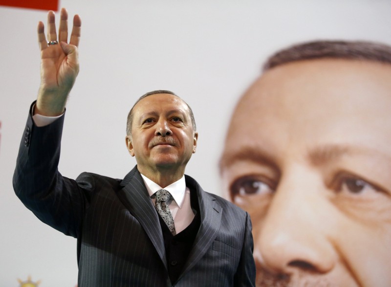 Turkish President Erdogan greets his supporters during a meeting of the ruling AK Party in Corum