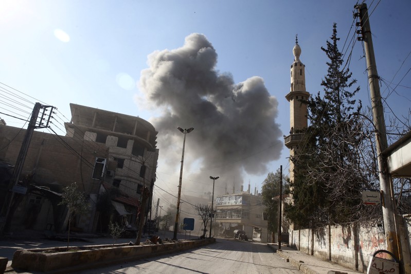 Smoke rises from the rebel held besieged town of Hamouriyeh