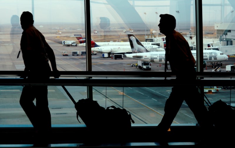 A flight crew walks through Denver International Airport in Denver