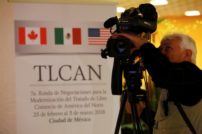 A cameraman films in front of a NAFTA banner at a hotel where the seventh round of NAFTA talks involving the United States, Mexico and Canada takes place, in Mexico City