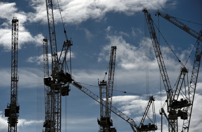 FILE PHOTO: Construction cranes are seen on a building site in central London