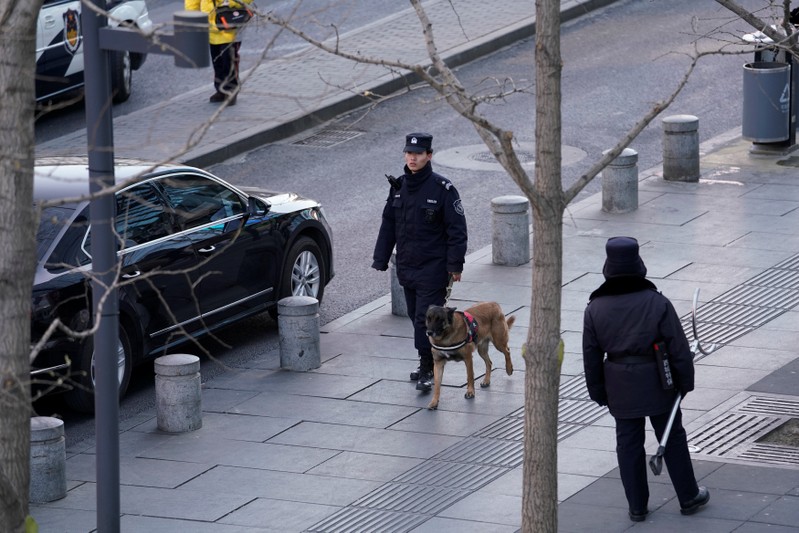 Police patrol outside the Joy City Mall in the Xidan district after a knife attack, in Beijing