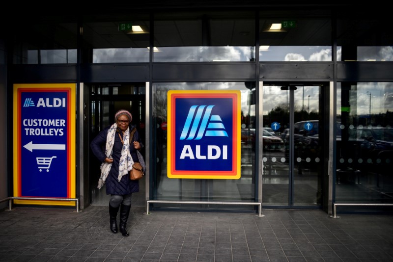 FILE PHOTO: A shopper leaves an Aldi store in London