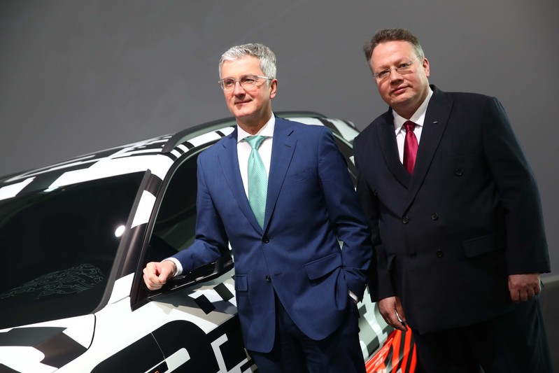 Audi CEO Stadler and CFO Seitz pose next to the Audi Q7 e-tron quatro car before the company's annual news conference in Ingolstadt