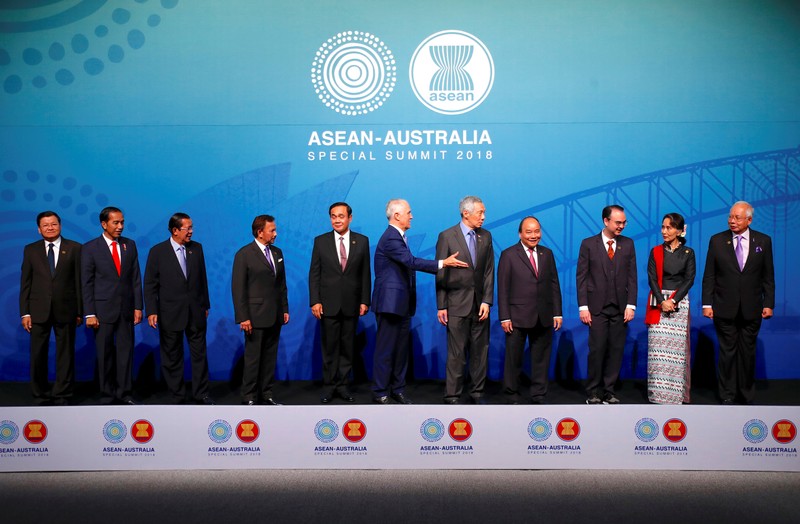 Australia's Prime Minister Malcolm Turnbull gestures to ASEAN leaders to leave the stage after the Family Photo during the one-off ASEAN summit in Sydney