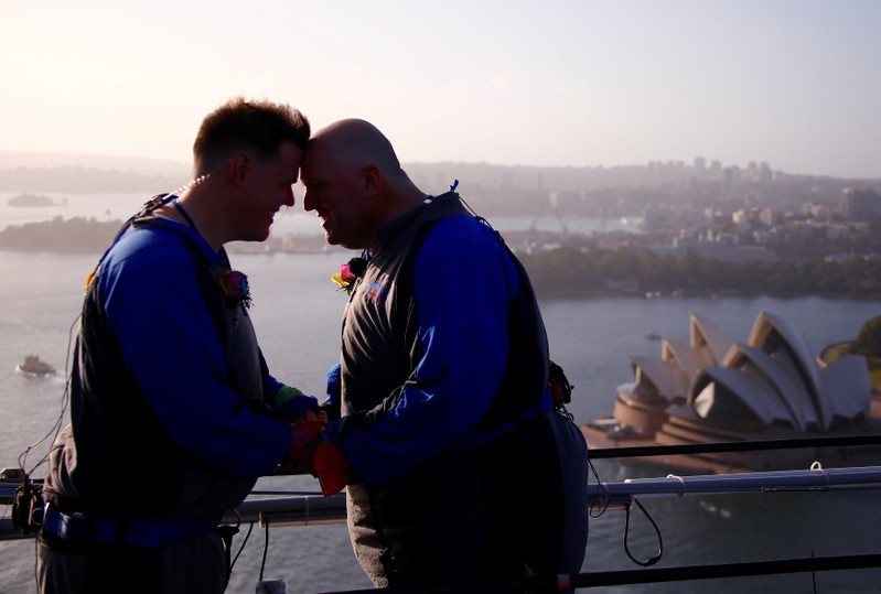 Warren Orlandi and Pauly Phillips react after they became the first same-sex couple to marry atop of the Sydney Harbour Bridge, just two days out from the 40th anniversary of the Sydney Gay and Lesbian Mardi Gras