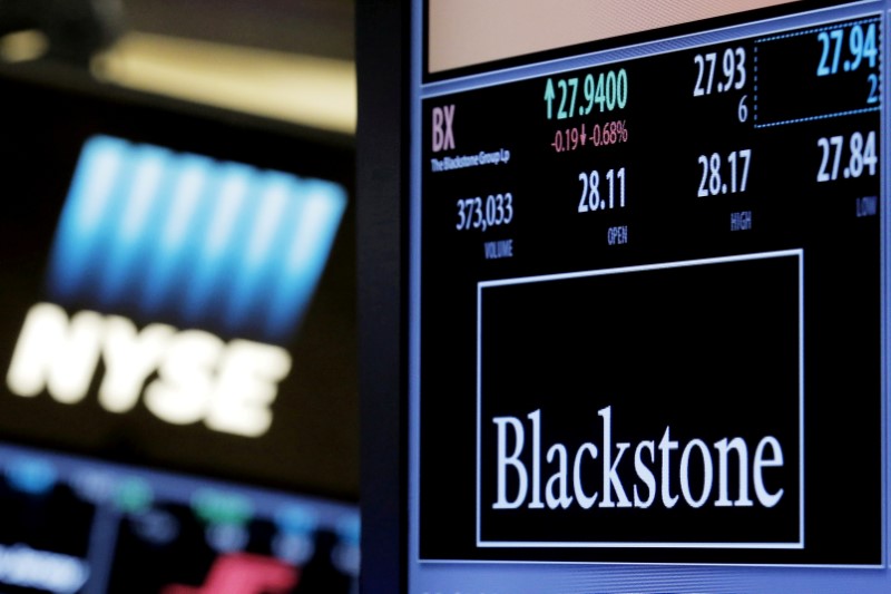 FILE PHOTO: The ticker and trading information for Blackstone Group is displayed at the post where it is traded on the floor of the New York Stock Exchange