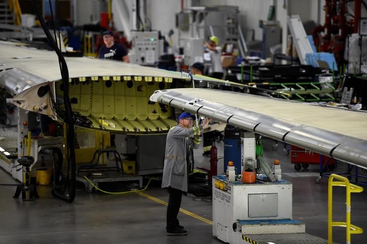 A worker inspects a C Series aeroplane wing in the Bombardier factory in Belfast