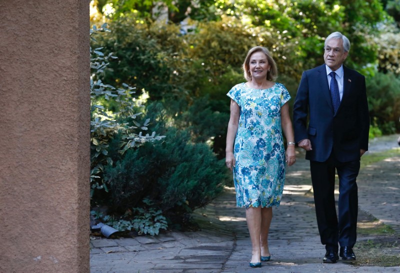 Chilean president-elect Sebastian Pinera walks his wife Cecilia Morel in front of his house in Santiago