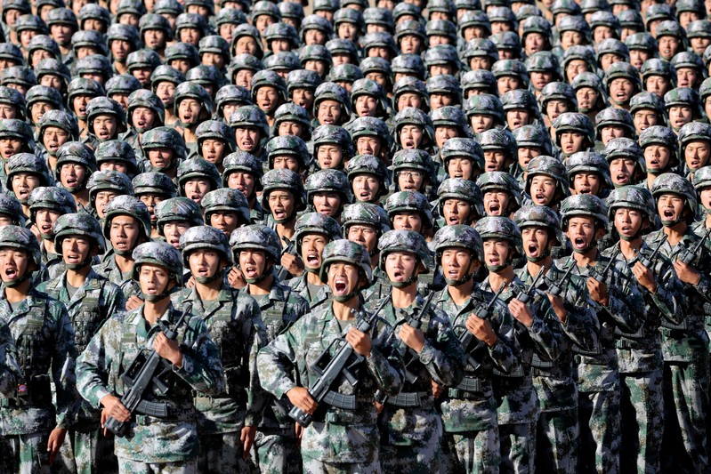 Soldiers of China's People's Liberation Army (PLA) get ready for the military parade to commemorate the 90th anniversary of the foundation of the army at Zhurihe military training base in Inner Mongolia Autonomous Region