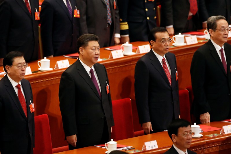 Chinese President Xi Jinping, Chinese Premier Li Keqiang and other officials sing national anthem during the closing session of the NPC at the Great Hall of the People in Beijing