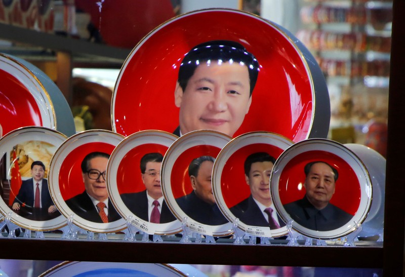 Souvenir plates featuring portraits of former and current Chinese leaders including President Xi Jinping and the late Chinese Chairman Mao Zedong are displayed for sale at a shop in Beijing