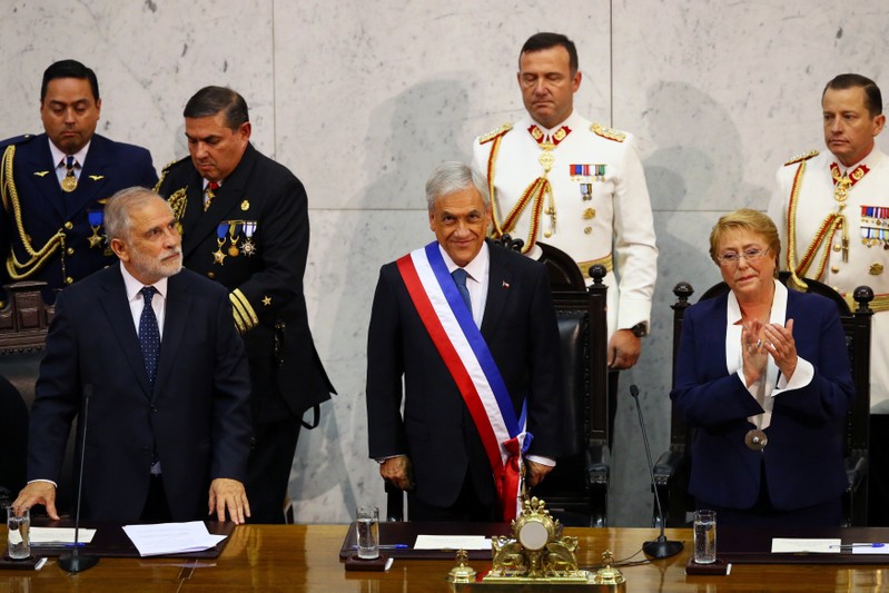 Chile's newly sworn in President Sebastian Pinera stands next to President of the Senate Carlos Montes and former president Michelle Bachelet at the Congress in Valparaiso