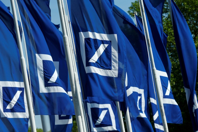 Flags with the logo of Deutsche Bank are seen at the headquarters ahead of the bank's annual general meeting in Frankfurt