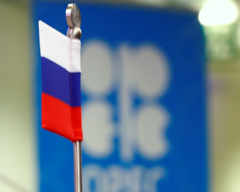 The Russian flag and the OPEC logo are seen before a news conference in Vienna