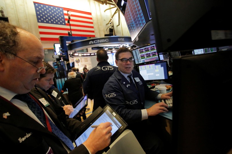 Traders work on the trading floor at the New York Stock Exchange (NYSE) in Manhattan, New York