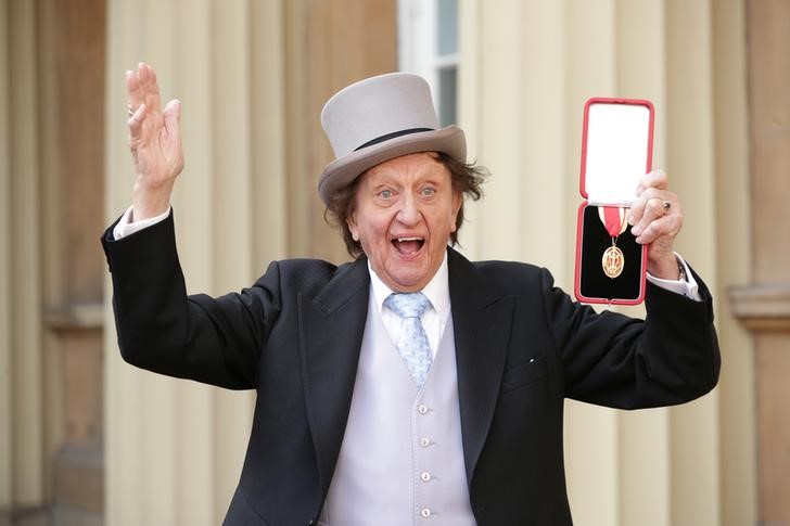 FILE PHOTO: Entertainer Ken Dodd poses for photographers after being made a Knight Bachelor of the British Empire by Britain's Prince William at an investiture at Buckingham Palace in central London