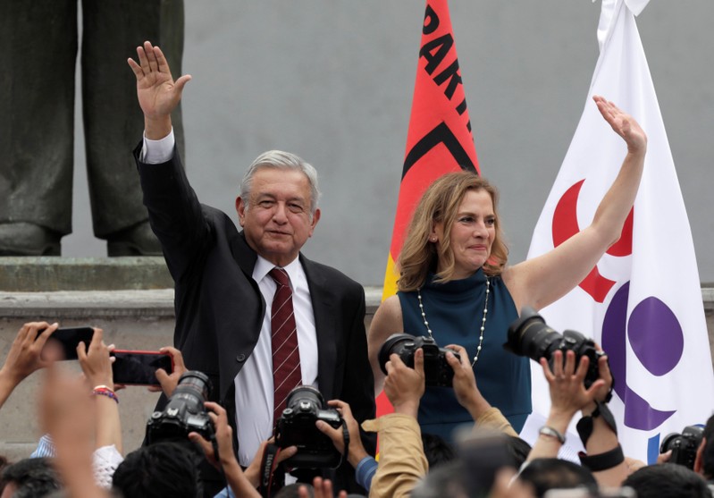 Leftist front-runner Andres Manuel Lopez Obrador, accompanied by his wife Beatriz Gutierrez Mueller, greets his supporters after being registered as a presidential candidate in Mexico City