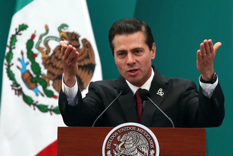 Mexico's President Enrique Pena Nieto gestures as he delivers a speech during the 80th anniversary of the expropriation of Mexico's oil industry in Mexico City