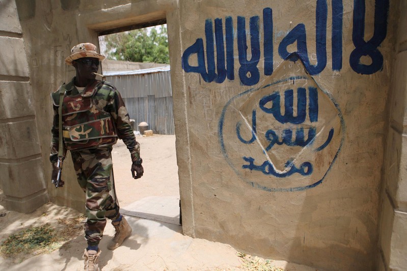 FILE PHOTO: A Nigerien soldier walks out of a house that residents say a Boko Haram militant had forcefully seized and occupied in Damasak