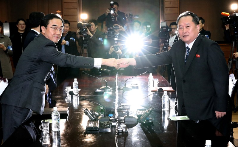 South Korean Unification Minister Cho Myoung-gyon and his North Korean counterpart Ri Son Gwon pose for photographs before their meeting at the truce village of Panmunjom