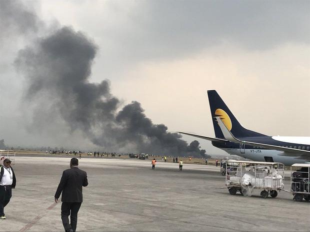 Passenger jet slides off runway, catches on fire in Nepal