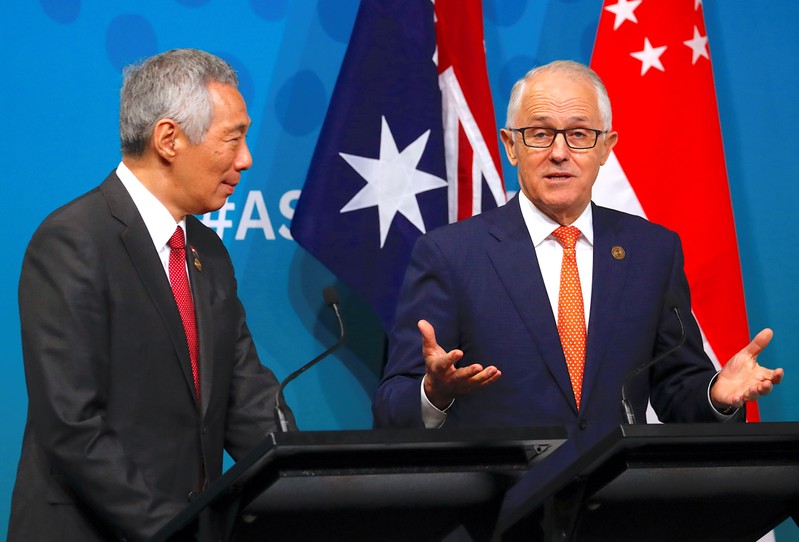 Australian Prime Minister Malcolm Turnbull walks behind Prime Minister of Singapore Lee Hsien Loong talk during their media conference during the one-off ASEAN summit in Sydney