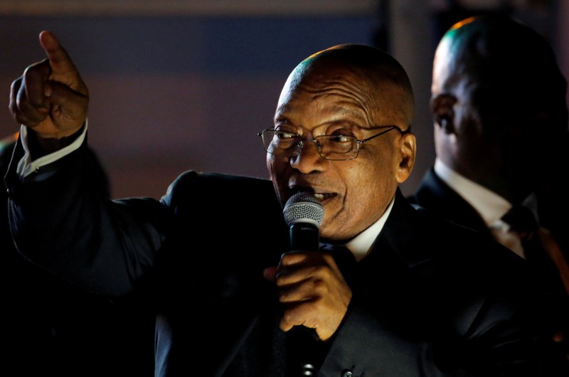 FILE PHOTO: South Africa's President Jacob Zuma celebrates with his supporters after he survived a no-confidence motion in parliament in Cape Town