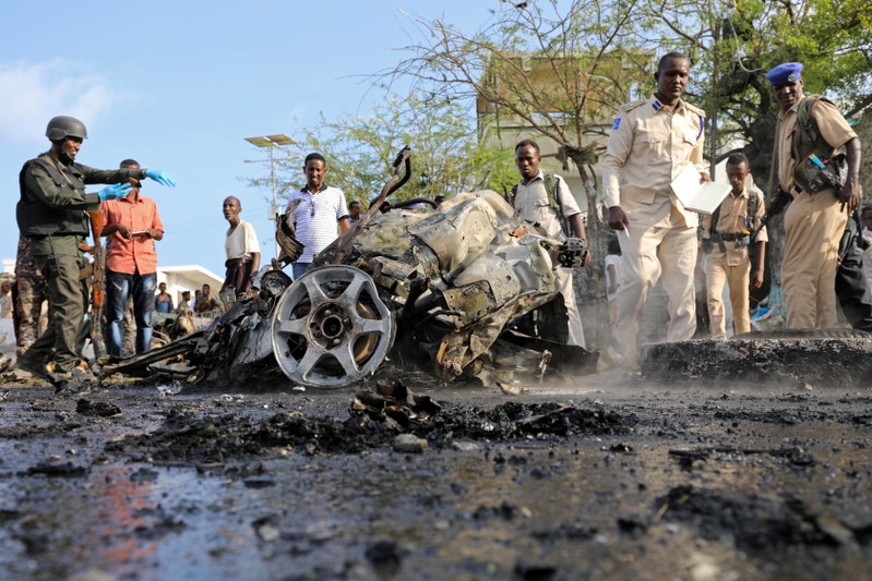 Somali security officers secure the scene of an explosion at a checkpoint near Somalia's parliament and interior ministry in Mogadishu