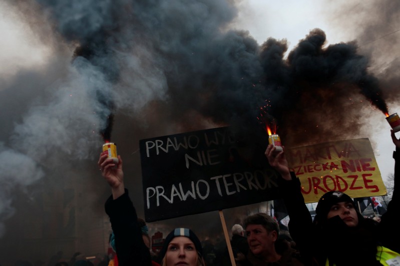 Protesters gather during a protest against plans to further restrict abortion laws in Warsaw
