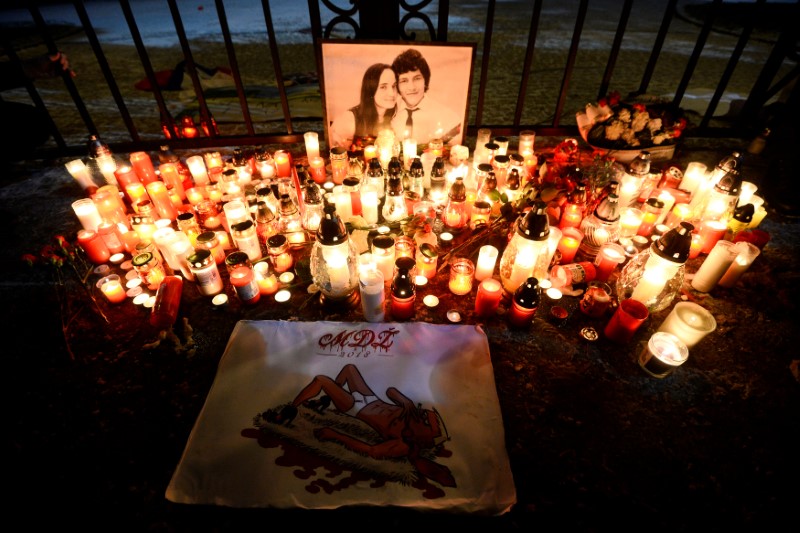 Candles are seen in front of the Government of the Slovak Republic's building during march in honour of murdered Slovak investigative reporter Jan Kuciak in Bratislava
