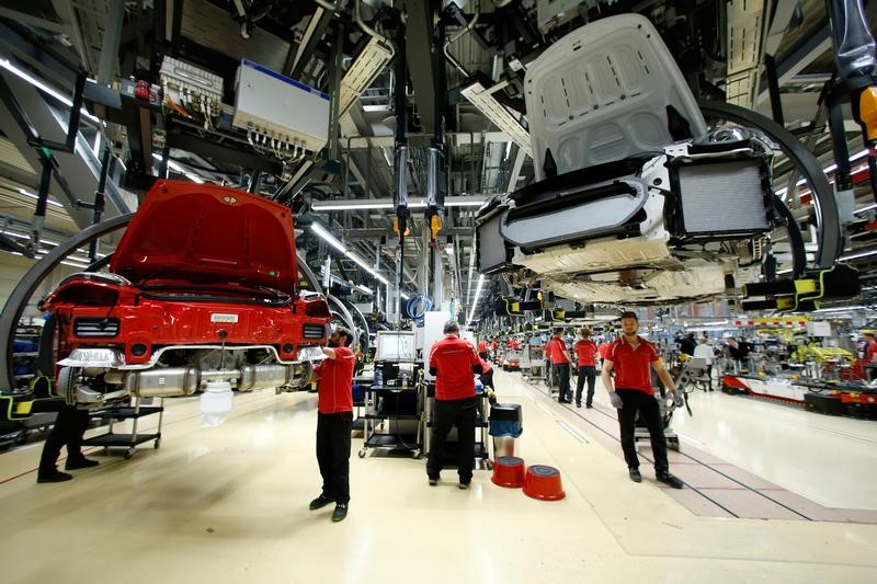 Employees of German car manufacturer Porsche assemble sports cars at the Porsche factory in Stuttgart-Zuffenhausen