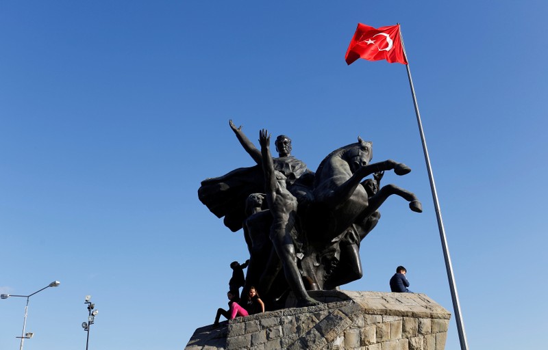 FILE PHOTO: Children sit at the Republic monument in Antalya