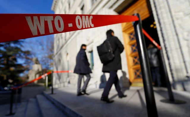 Delegates arrive at the World Trade Organization (WTO) headquarters in Geneva
