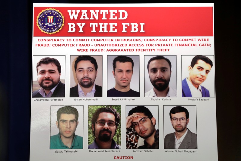 Pictures of nine Iranians charged with conducting massive cyber theft campaign are on display