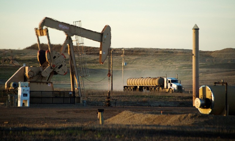 FILE PHOTO: A service truck drives past an oil well on the Fort Berthold Indian Reservation in North Dakota
