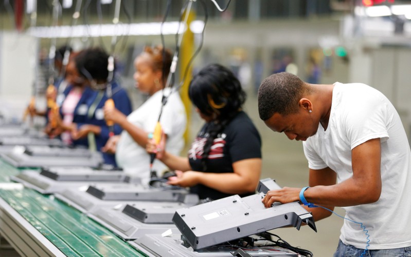 FILE PHOTO: Workers on the assembly line replace the back covers of 32-inch TV sets at Element Electronics in Winnsboro