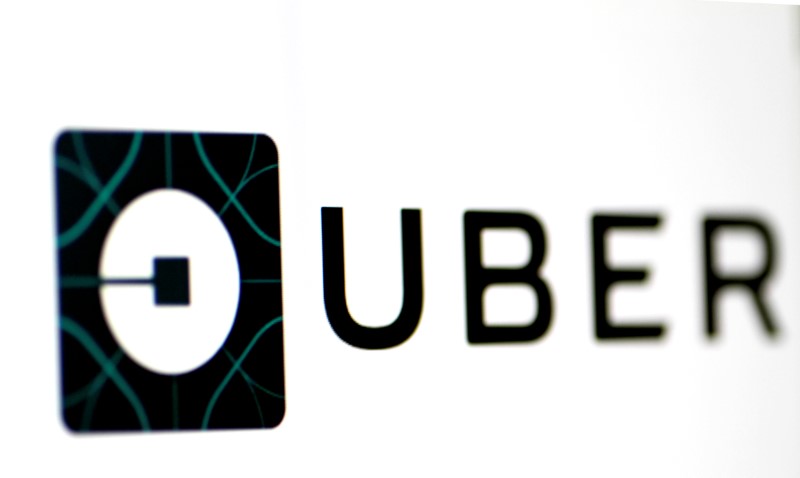 The Uber logo is seen on a screen in Singapore