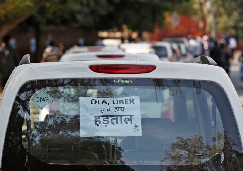 FILE PHOTO: A note is pasted on a rear window of a car during a protest by Uber and Ola drivers, in New Delhi