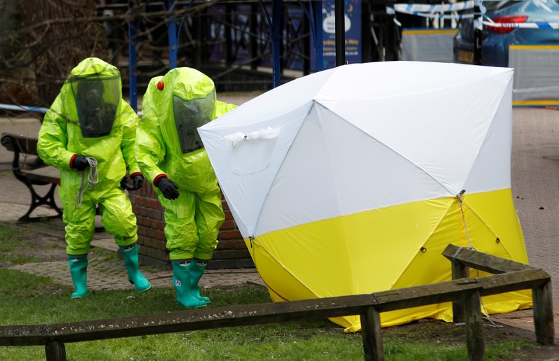 The forensic tent, covering the bench where Sergei Skripal and his daughter Yulia were found, is repositioned by officials in protective suits in the centre of Salisbury