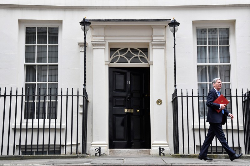 Britain's Chancellor of the Exchequer Philip Hammond leaves 11 Downing Street to deliver his half-yearly update on the public finances, in London