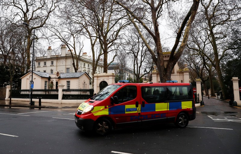 A police van drives out of Kensington Palace Gardens, past Russia's Embassy in London