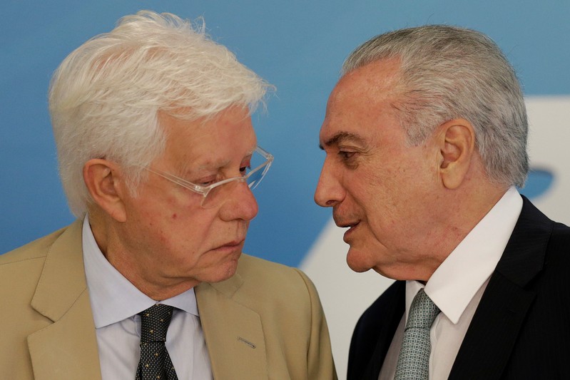 Brazil's President Michel Temer speaks with Minister of the General Secretariat of the Presidency of Brazil Wellington Moreira Franco during a ceremony to sanction flexible broadcast schedule of the Voice of Brazil radio program, in Brasilia