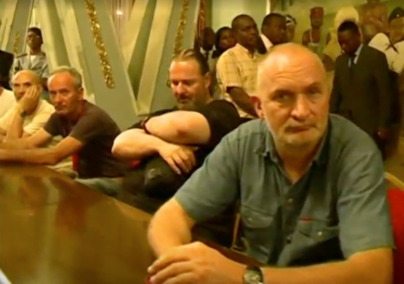 Tourists, who were held hostage, sit after they were freed in Yaounde