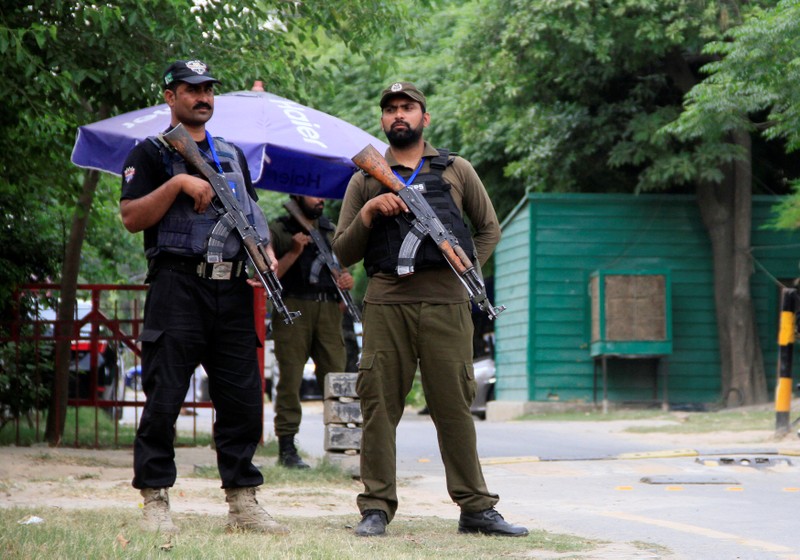 Policemen stand guard on a street leading to the residence of a Pakistani Supreme Court's judge, after unknown gunman fired shots at the building, in Lahore