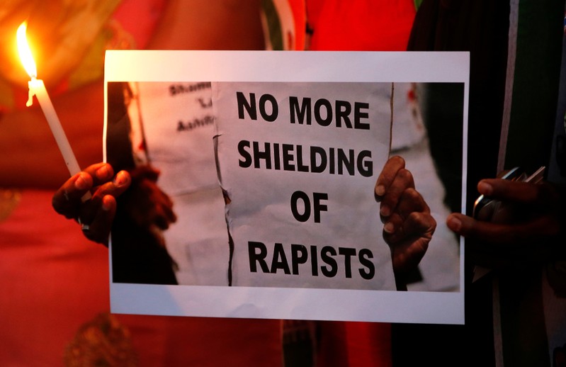 FILE PHOTO - Supporters of India's main opposition Congress party participate in a candle light vigil as they protest against the rape of an eight-year-old girl in Kathua near Jammu, and a teenager in Unnao, Uttar Pradesh state, in Ahmedabad