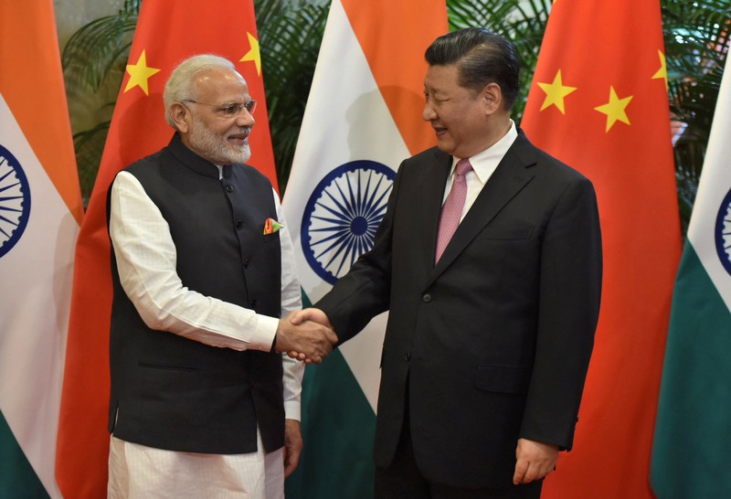 Chinese President Xi Jinping shakes hands with Indian Prime Minister Narendra Modi during their visit at East Lake Guest House, in Wuhan