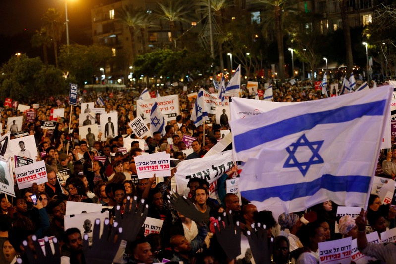 FILE PHOTO: Pepole take part in a protest against the Israeli government's plan to deport African migrants, in Tel Aviv